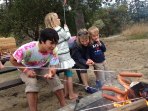 Roasting hot dogs on Campfire